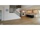 Open-concept living area with hardwood floors, a staircase, and a modern kitchen, perfect for entertaining and Gathering gatherings at 1144 Ridgevine Rd, Greenwood, IN 46143