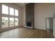 Bright living room with tall stone fireplace, large windows, and hardwood floors, creating a cozy and inviting space at 1144 Ridgevine Rd, Greenwood, IN 46143