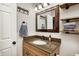A charming bathroom vanity with a granite countertop, wooden accents and stylish mirror at 12301 Van Spronsen Ct, Indianapolis, IN 46236