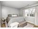 Comfortable bedroom featuring natural light, a full-size bed, and a cozy bench by the window at 12301 Van Spronsen Ct, Indianapolis, IN 46236