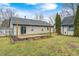 Back exterior view of home with deck, shed, and grass area under a bright blue sky at 12301 Van Spronsen Ct, Indianapolis, IN 46236