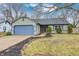 Charming single-story home with a blue garage door and beautifully landscaped front yard at 12301 Van Spronsen Ct, Indianapolis, IN 46236