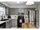 Updated kitchen with modern appliances, gray cabinets, and a stylish eat-in kitchen island at 12301 Van Spronsen Ct, Indianapolis, IN 46236