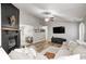Bright living area featuring a brick fireplace, hardwood floors, and a comfortable seating arrangement at 12301 Van Spronsen Ct, Indianapolis, IN 46236