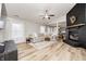 Spacious living room boasting hardwood floors, large windows, a ceiling fan and a modern brick fireplace at 12301 Van Spronsen Ct, Indianapolis, IN 46236