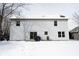 View of backyard with a snow-covered lawn and two-story home with sliding glass door at 12643 Feldspar Rd, Indianapolis, IN 46236