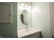 Bright bathroom with a round mirror, sink, and silver hardware at 12643 Feldspar Rd, Indianapolis, IN 46236