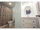 Bright bathroom with a shower-tub combination, toilet, and a single sink vanity at 12643 Feldspar Rd, Indianapolis, IN 46236