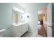 Bright bathroom with a double sink vanity and view into the bedroom at 12643 Feldspar Rd, Indianapolis, IN 46236