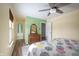Bright bedroom with ceiling fan, wood dresser, and view into the bath at 12643 Feldspar Rd, Indianapolis, IN 46236