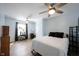 Bedroom with two fans, desk, plants and a bed with white sheets at 12643 Feldspar Rd, Indianapolis, IN 46236