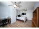 Bedroom with two fans, desk, shelves and a bed with white sheets at 12643 Feldspar Rd, Indianapolis, IN 46236