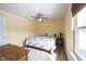 This sunny bedroom has neutral walls, a ceiling fan, and a queen sized bed at 12643 Feldspar Rd, Indianapolis, IN 46236