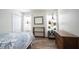 Bedroom with lots of plants, wood dresser, and light from two windows at 12643 Feldspar Rd, Indianapolis, IN 46236