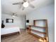 Bedroom with two fans, tv, shelves and a bed with white sheets at 12643 Feldspar Rd, Indianapolis, IN 46236