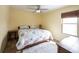 This sunny bedroom has neutral walls, a ceiling fan, and a queen sized bed at 12643 Feldspar Rd, Indianapolis, IN 46236