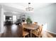 Open-concept living space with hardwood floors, featuring a dining area and inviting living room at 12643 Feldspar Rd, Indianapolis, IN 46236