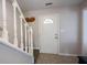 Inviting entryway featuring a white front door with decorative window and stairway at 12643 Feldspar Rd, Indianapolis, IN 46236