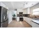 Well-lit kitchen with stainless steel appliances, white cabinets, and open layout at 12643 Feldspar Rd, Indianapolis, IN 46236
