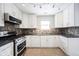 Updated kitchen with modern stainless steel appliances, ample counter space, and stylish cabinets at 12643 Feldspar Rd, Indianapolis, IN 46236