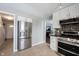 Modern kitchen with stainless steel fridge, stainless steel range, and open access to the living space at 12643 Feldspar Rd, Indianapolis, IN 46236