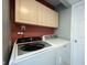 Functional laundry area with modern appliances and overhead storage at 12643 Feldspar Rd, Indianapolis, IN 46236