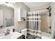 Cozy bathroom featuring a shower-tub combination with a striped curtain and a mirrored vanity at 1442 Northbrook Dr, Indianapolis, IN 46260
