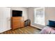 Bedroom with hardwood floors, dresser, and natural light from a window at 1442 Northbrook Dr, Indianapolis, IN 46260