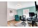 Bedroom with hardwood floors, teal accent wall, and two windows for natural light at 1442 Northbrook Dr, Indianapolis, IN 46260