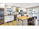 Well-lit kitchen featuring stainless steel appliances, white cabinets, and a center island at 1442 Northbrook Dr, Indianapolis, IN 46260