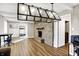 Open-concept living room featuring a stone fireplace and lots of natural light at 1442 Northbrook Dr, Indianapolis, IN 46260