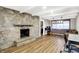 Inviting living room with a stone fireplace, wood floors, and natural light at 1442 Northbrook Dr, Indianapolis, IN 46260