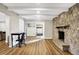 Spacious living room with a stone fireplace, wood floors, and neutral paint at 1442 Northbrook Dr, Indianapolis, IN 46260