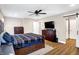 Spacious main bedroom with ceiling fan, TV, and ensuite bathroom at 1442 Northbrook Dr, Indianapolis, IN 46260