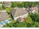 Aerial view showcases the home’s backyard, featuring a spacious lawn, patio, and lush landscaping at 18725 Wychwood Pl, Noblesville, IN 46062