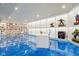 Finished basement featuring bright floors, a white desk, and display shelving at 18725 Wychwood Pl, Noblesville, IN 46062