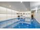 Finished basement featuring bright floors, a white desk, and display shelving at 18725 Wychwood Pl, Noblesville, IN 46062