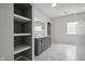 Bright bathroom with double vanity, quartz countertops, an LED mirror, and built-in shelving at 18725 Wychwood Pl, Noblesville, IN 46062