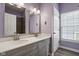 Bathroom with a double vanity, large mirrors, and a window at 18725 Wychwood Pl, Noblesville, IN 46062