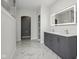 Bright bathroom with double vanity, quartz countertops, an LED mirror, and marble-look tiled floors at 18725 Wychwood Pl, Noblesville, IN 46062