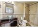 Well-lit bathroom boasts a glass vessel sink, granite countertop, tiled shower, and elegant finishes at 18725 Wychwood Pl, Noblesville, IN 46062