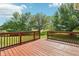 View from wood deck overlooks well-maintained lawn and mature trees against a blue sky at 18725 Wychwood Pl, Noblesville, IN 46062