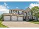 Attractive two-story home with a large driveway, a three-car garage, and mature landscaping at 18725 Wychwood Pl, Noblesville, IN 46062