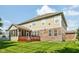 The backyard shows the tan siding and brickwork details on this two-story home at 18725 Wychwood Pl, Noblesville, IN 46062