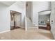 Spacious open-concept foyer with staircase, hardwood floors, and high ceilings at 18725 Wychwood Pl, Noblesville, IN 46062