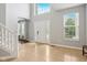 Bright foyer with tile flooring, staircase, high ceiling, and view of the front yard at 18725 Wychwood Pl, Noblesville, IN 46062