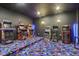 Retro game room equipped with arcade machines, stools, and vibrant carpeting for hours of entertainment at 18725 Wychwood Pl, Noblesville, IN 46062
