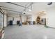 Spacious three car garage with epoxy flooring and ample storage and organizational capabilities at 18725 Wychwood Pl, Noblesville, IN 46062