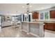 Open kitchen with granite countertops, cherry cabinets, stainless steel appliances, and views of the dining and living areas at 18725 Wychwood Pl, Noblesville, IN 46062