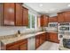 Kitchen featuring cherry cabinets, granite countertops, stainless steel appliances and a large window for natural light at 18725 Wychwood Pl, Noblesville, IN 46062